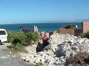 Limestone from the cellar and foundation excavation is set aside for later use -- outside stairs, pillar and a boundary