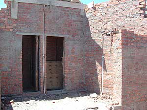 The future kitchen, with doorways for the pantry (left) and laundry (right)