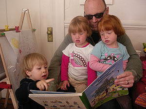 ca_girls If we're fortunate, Calvin will realize just how lucky he was to hang out with two of the cutest girls around! Here they're all enjoying a German children's book! Lots more fun was had racing pushcars up and down the corridor, and even taking turns!