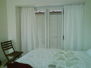 A bed I'd like to dive into. I was excited by this photo because it showed the shutters from the inside, the curtains in place, and the linen I had great joy selecting. 