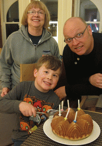 Calvin, Grammy and Jay officiate the cutting of the still-warm birthday cake that C and I baked.